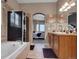 Bright bathroom with double sinks, a separate shower, and a bathtub, designed for relaxation and comfort at 413 N De Gaulle Ct, Aurora, CO 80018