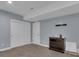 Neutral painted bedroom has a closet with double doors, as well as a small black dresser at 413 N De Gaulle Ct, Aurora, CO 80018