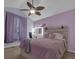 Inviting bedroom with lavender walls, a stylish vanity area, and comfortable furnishings with lots of light at 413 N De Gaulle Ct, Aurora, CO 80018