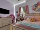 Bedroom featuring a bed and desk with pink curtains and decor at 413 N De Gaulle Ct, Aurora, CO 80018
