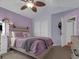 Vaulted primary bedroom with purple walls, ceiling fan, and closet at 413 N De Gaulle Ct, Aurora, CO 80018