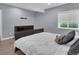 Bedroom with a decorative headboard bed, neutral colors, and a window at 413 N De Gaulle Ct, Aurora, CO 80018
