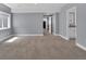 Spacious bonus room with carpet, neutral paint, and access to bathroom and other rooms at 413 N De Gaulle Ct, Aurora, CO 80018