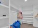 Walk-in closet with built-in shelving and hanging storage space for clothing at 413 N De Gaulle Ct, Aurora, CO 80018