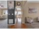 Hallway with hardwood floors that leads to an open-concept dining and living space at 413 N De Gaulle Ct, Aurora, CO 80018