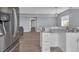 Kitchen with white cabinets, gray countertop, and stainless steel refrigerator at 413 N De Gaulle Ct, Aurora, CO 80018