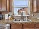 Close-up of kitchen sink and counter with granite countertops and modern fixtures at 413 N De Gaulle Ct, Aurora, CO 80018