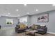 Bright living room with two sofas, recessed lighting, and an open view to the kitchen area at 413 N De Gaulle Ct, Aurora, CO 80018