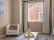 Bright living room with neutral colors, plush carpet, and a stylish coffee table at 413 N De Gaulle Ct, Aurora, CO 80018