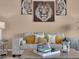 Bright living room featuring a plush sofa with decorative pillows and modern decor at 413 N De Gaulle Ct, Aurora, CO 80018
