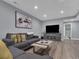 Open concept living room with a sectional sofa, television, and modern artwork at 413 N De Gaulle Ct, Aurora, CO 80018