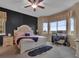 Well-lit main bedroom with a cozy bed, workspace by the window, and a serene atmosphere at 413 N De Gaulle Ct, Aurora, CO 80018