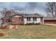 Spacious backyard with a lush lawn, patio area, and mature trees at 2641 S Magnolia St, Denver, CO 80224