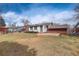 Expansive backyard with a patio, lawn, and mature trees, perfect for outdoor activities at 2641 S Magnolia St, Denver, CO 80224