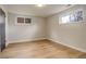 Basement area with hardwood floors and two windows at 2641 S Magnolia St, Denver, CO 80224