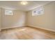Bright basement area with two windows and hardwood floors at 2641 S Magnolia St, Denver, CO 80224