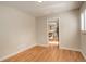 Inviting bedroom with wood floors and a view into the kitchen through an open doorway at 2641 S Magnolia St, Denver, CO 80224