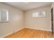 Bright bedroom with light walls, wood floors, and white shuttered windows providing natural light at 2641 S Magnolia St, Denver, CO 80224