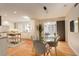 Dining area with a modern glass table and seamless transition into the kitchen space at 2641 S Magnolia St, Denver, CO 80224