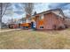 Front exterior displaying brick, wood, blue door, and landscaping at 2641 S Magnolia St, Denver, CO 80224