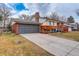 Angle shot of the front exterior, showing the garage and well-maintained lawn at 2641 S Magnolia St, Denver, CO 80224