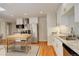 Bright kitchen features stainless steel appliances, granite countertops, island with butcher block top, and hardwood floors at 2641 S Magnolia St, Denver, CO 80224