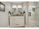 Modern main bathroom features double sinks, decorative mirrors, and a beautifully tiled shower and tub at 2641 S Magnolia St, Denver, CO 80224