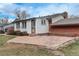 Backyard patio with flagstone and partial view of the white siding on the home's exterior at 2641 S Magnolia St, Denver, CO 80224
