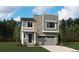 Modern two-story home featuring a stone facade, gray siding, and an attached two-car garage at 11217 Mount Emma Dr, Englewood, CO 80112