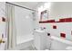 Bathroom with tub, white subway tile, decorative tiles and updated vanity at 1241 Wabash St, Denver, CO 80220