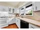 Eat-in kitchen featuring butcher block countertops, subway tile backsplash and white cabinets at 1241 Wabash St, Denver, CO 80220