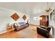 Cozy living room features wood floors, leather couch, earth tone rug and unique wall art at 1241 Wabash St, Denver, CO 80220
