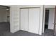 Spacious bedroom boasts a built-in bookshelf and closet with sliding doors at 13952 E Marina Dr # 304, Aurora, CO 80014