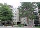 Attractive multi-story condo building with mature trees and well-maintained landscaping at 13952 E Marina Dr # 304, Aurora, CO 80014