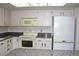 Bright kitchen features granite countertops and clean white appliances at 13952 E Marina Dr # 304, Aurora, CO 80014