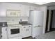 This kitchen includes matching white appliances and granite countertops at 13952 E Marina Dr # 304, Aurora, CO 80014