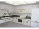 Cozy kitchen with white cabinets, granite countertops, and a unique ceiling fixture at 13952 E Marina Dr # 304, Aurora, CO 80014