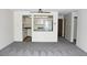 Open-concept living room with kitchen view, modern fan, and ample space at 13952 E Marina Dr # 304, Aurora, CO 80014