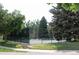 Tennis court in the community, surrounded by mature trees and landscaping at 13952 E Marina Dr # 304, Aurora, CO 80014