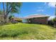 Spacious backyard featuring lush lawn, mature trees, and a picnic table at 1666 S Bryant St, Denver, CO 80219