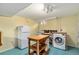 Basement kitchen space with appliances and a movable island at 1666 S Bryant St, Denver, CO 80219