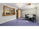 Spacious basement area featuring a rustic sliding barn door and a pass through to the kitchen at 1666 S Bryant St, Denver, CO 80219