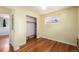 Cozy bedroom with hardwood floors, closet, and bright yellow walls at 1666 S Bryant St, Denver, CO 80219