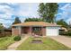 Lovely single-story brick home with a well-kept lawn and attached garage at 1666 S Bryant St, Denver, CO 80219
