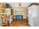 Functional kitchen boasting open shelving, a vintage-style stove, and natural light at 1666 S Bryant St, Denver, CO 80219