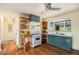 Well-lit kitchen showcasing open shelving, a vintage-style stove, and updated fixtures at 1666 S Bryant St, Denver, CO 80219
