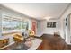 Bright living room with hardwood floors, large windows, and a trendy color palette at 1666 S Bryant St, Denver, CO 80219