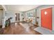 Open-concept living room featuring hardwood floors and a bright accent wall at 1666 S Bryant St, Denver, CO 80219