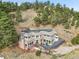 Aerial view of custom home with expansive decks surrounded by trees at 6057 Red Hill Rd, Boulder, CO 80302