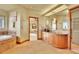 Elegant bathroom with a large vanity, soaking tub, and access to the bedroom at 6057 Red Hill Rd, Boulder, CO 80302
